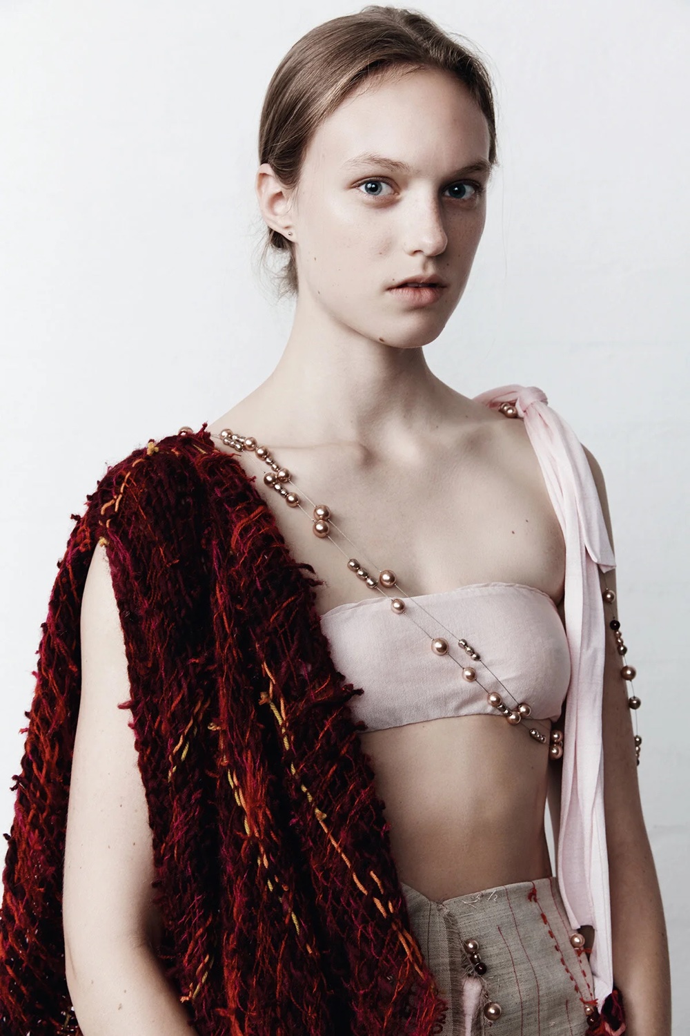 Magenta strapless dress with cut-outs and pearl strands